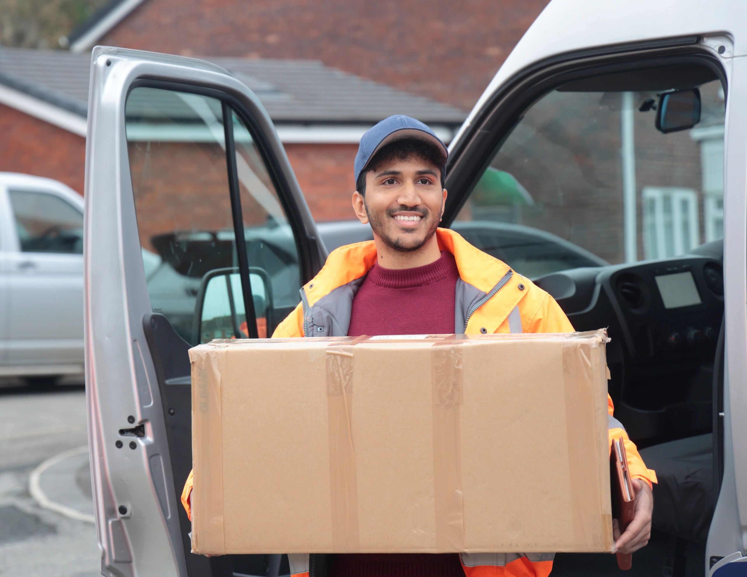 Courier delivery person holding parcels, representing order shipping and tracking